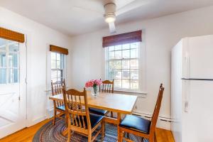 a dining room with a table and chairs and a refrigerator at Edgartown Cozy Corner in Edgartown