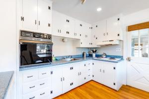 a kitchen with white cabinets and blue counter tops at Edgartown Cozy Corner in Edgartown