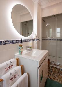 a bathroom with a sink and a mirror at Santos da Vila in Sintra +58 photos