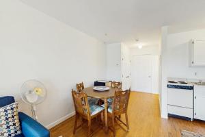 a kitchen and dining room with a table and chairs at Large Studio with Patio and Pool in North Truro