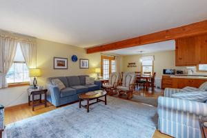 a living room with a couch and a table at Serene Cape Escape in Wellfleet