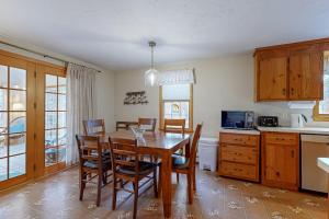 a kitchen and dining room with a table and chairs at Serene Cape Escape in Wellfleet