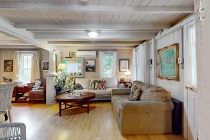 a living room with a couch and a table at Seabreeze Retreat in Oak Bluffs