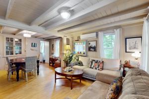 a living room with a couch and a table at Seabreeze Retreat in Oak Bluffs