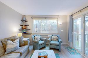 a living room with a couch and two chairs at The Condo at Ocean Edge in Brewster