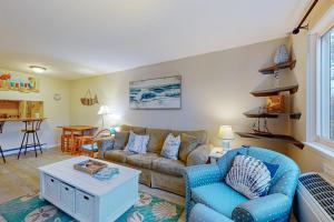 a living room with a couch and a table at The Condo at Ocean Edge in Brewster
