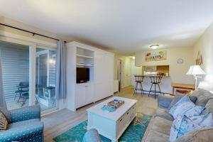 a living room with a couch and a table at The Condo at Ocean Edge in Brewster