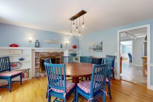 a dining room with a wooden table and chairs at Brewster Getaway in Brewster +17 photos
