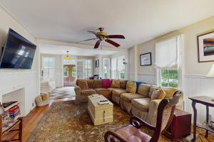 a living room with a couch and a ceiling fan at Beach House in Oak Bluffs