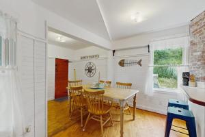 a kitchen and dining room with a table and chairs at Beach House in Oak Bluffs