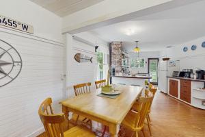 a kitchen and dining room with a wooden table and chairs at Beach House in Oak Bluffs