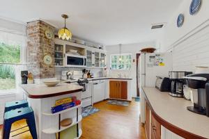 a kitchen with white cabinets and a counter top at Beach House in Oak Bluffs