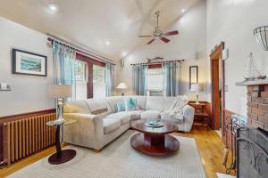 a living room with a couch and a fireplace at Mermaid Cottage in Falmouth