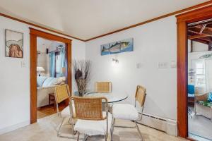 a dining room with a table and chairs and a bedroom at Mermaid Cottage in Falmouth