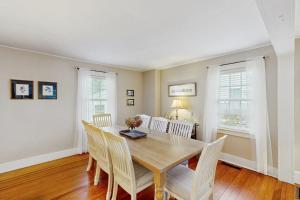 a dining room with a wooden table and chairs at Edgartown Village in Edgartown