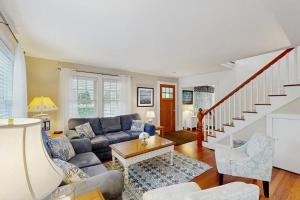 a living room with a couch and a table at Edgartown Village in Edgartown