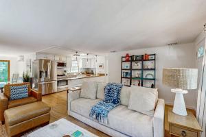 a living room with a couch and a chair at Miles Away in South Dennis