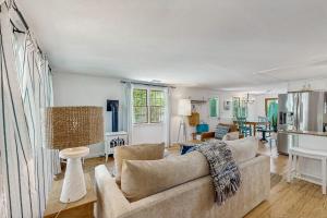 a living room with a couch and a table at Miles Away in South Dennis