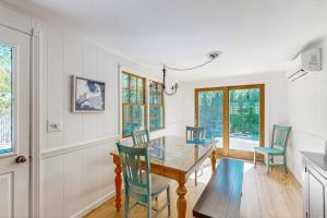 a dining room with a glass table and chairs at Miles Away in South Dennis