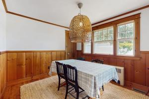 a dining room with a table and a chandelier at The Cygnet in Falmouth