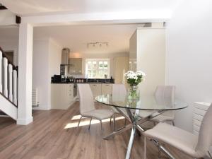 a dining room with a glass table and white chairs at 2 Bed in Lamesley oc-cn107 in Lamesley