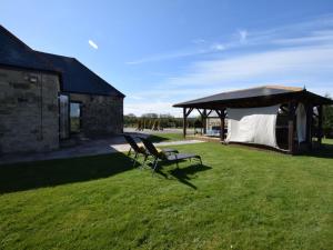 two chairs and a gazebo in a yard at 2 Bed in Lamesley oc-cn107 in Lamesley