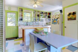 a kitchen with a table and a ceiling fan at Sunset Meadows in Oak Bluffs