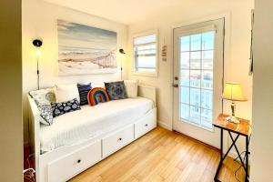 a bed in a room with a window at Bayside Beauty in Truro