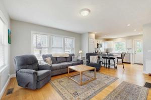 a living room with a couch and chairs and a table at Bella Luna in Falmouth +16 photos