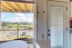 a room with a window with a view of a balcony at Sand & Beach Within Reach in North Truro +14 photos