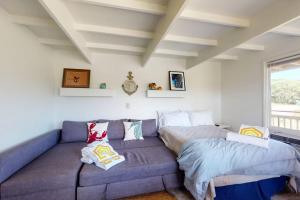 a living room with a couch and a bed at Sand & Beach Within Reach in North Truro