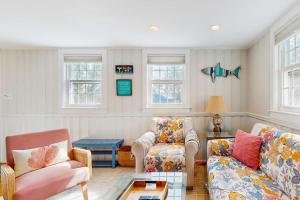 a living room with two couches and a table at Lucky Number Seven in Chatham