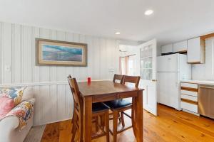 a kitchen with a table and chairs in a room at Lucky Number Seven in Chatham