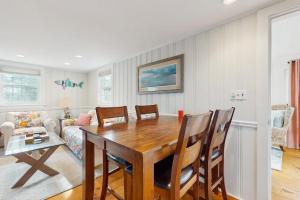a dining room with a wooden table and chairs at Lucky Number Seven in Chatham +14 photos