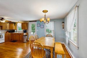 a kitchen with a dining room table and chairs at Winthrop Cottage in Oak Bluffs