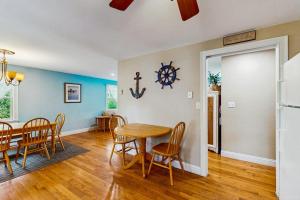 a kitchen and dining room with a table and chairs at Winthrop Cottage in Oak Bluffs