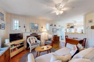 a living room with a couch and a tv at The Spray in Harwich Port