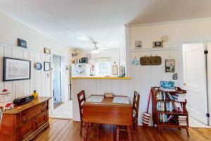a kitchen with a table and chairs and a desk at The Spray in Harwich Port