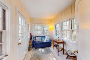a living room with a blue couch and windows at The Spray in Harwich Port