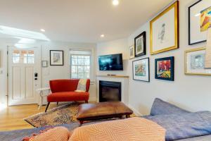 a living room with a couch and a fireplace at Summer Sun in Provincetown