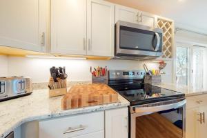 a kitchen with a stove and a microwave at Summer Sun in Provincetown