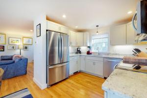 a kitchen with a stainless steel refrigerator and a blue couch at Summer Sun in Provincetown +20 photos