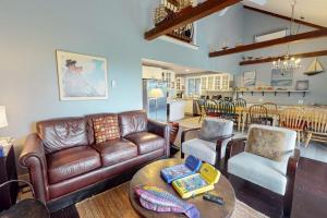 a living room with a couch and a table at Bayview in Truro
