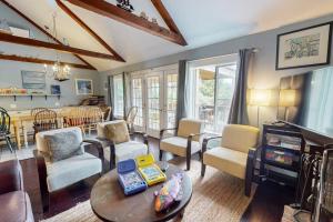 a living room filled with furniture and a dining room at Bayview in Truro