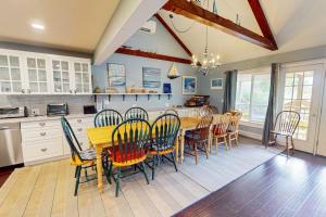 a dining room with a table and chairs in a kitchen at Bayview in Truro