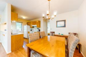 a kitchen and dining room with a wooden table at Relaxing Cape Getaway in Brewster