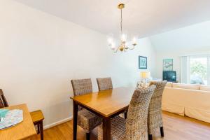 a dining room with a table and chairs and a couch at Relaxing Cape Getaway in Brewster