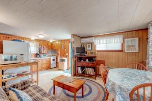 a kitchen and living room with a bed and a table at Villa Fairview in South Dennis