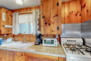 a kitchen with a sink and a stove top oven at Villa Fairview in South Dennis