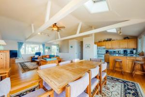 a kitchen and living room with a wooden table and chairs at Beaches n' Sunsets in Eastham